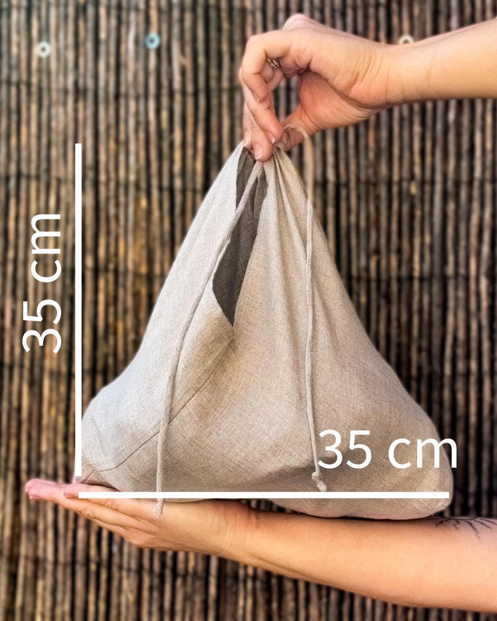 Hand holding a linen bread bag, 35 × 35 cm size