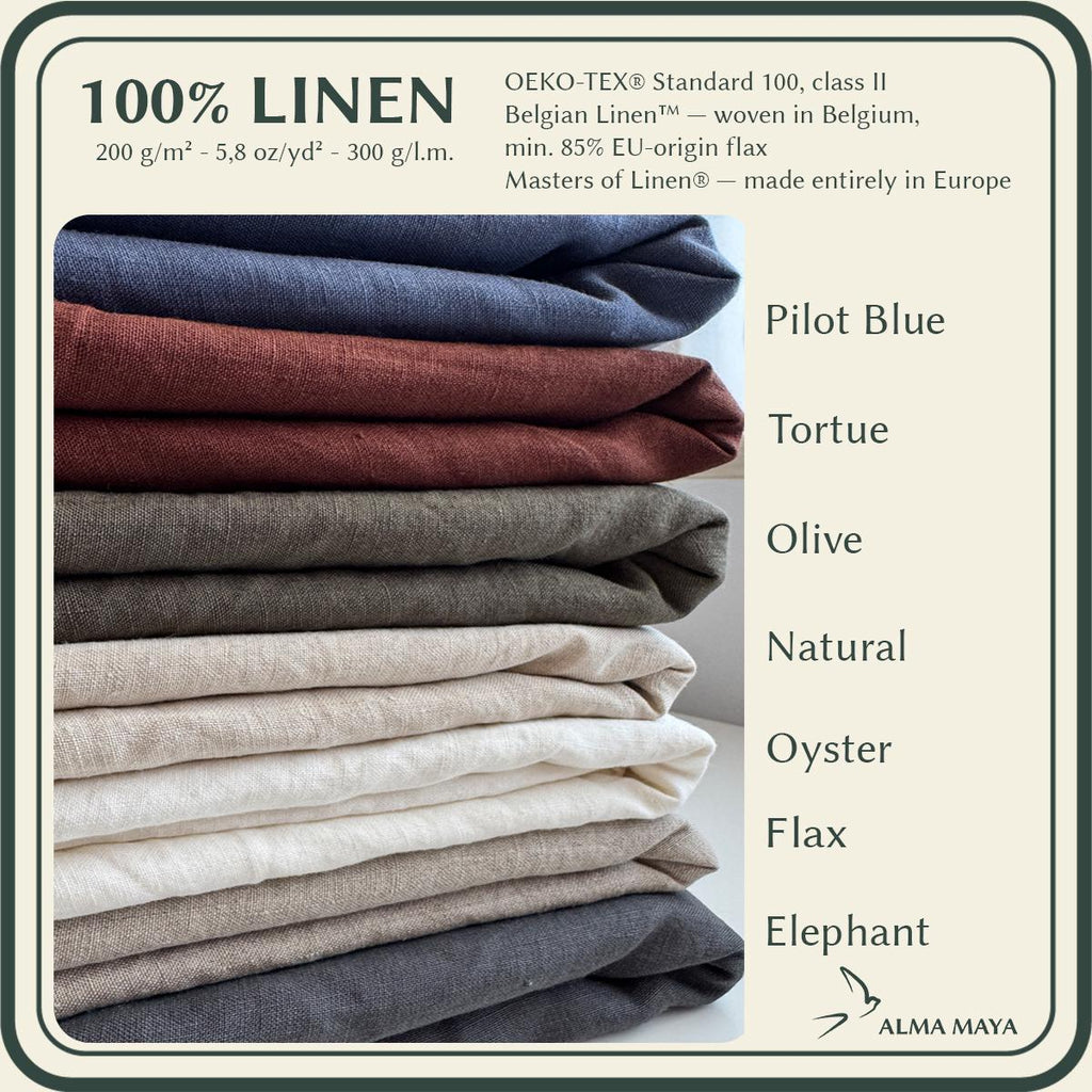 A linen fabric color selection graphic showing a stack of folded linen textiles in multiple shades, with text listing the available colors: Pilot Blue, Tortue, Olive, Natural, Oyster, Flax, and Elephant. The brand name Alma Maya appears at the bottom.